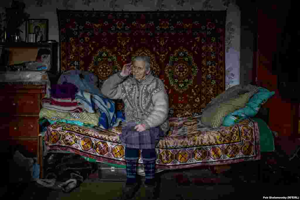 Раиса Казакова внутри своего дома, где она живет с 9 другими пенсионерами. Все они потеряли свои дома при обстрелах. 