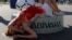 RUSSIA -- An activist attends a protest against torture, next to the World Cup mascot Zabivaka, outside the Saint Petersburg stadium in St. Petersburg, Russia July 3, 2018